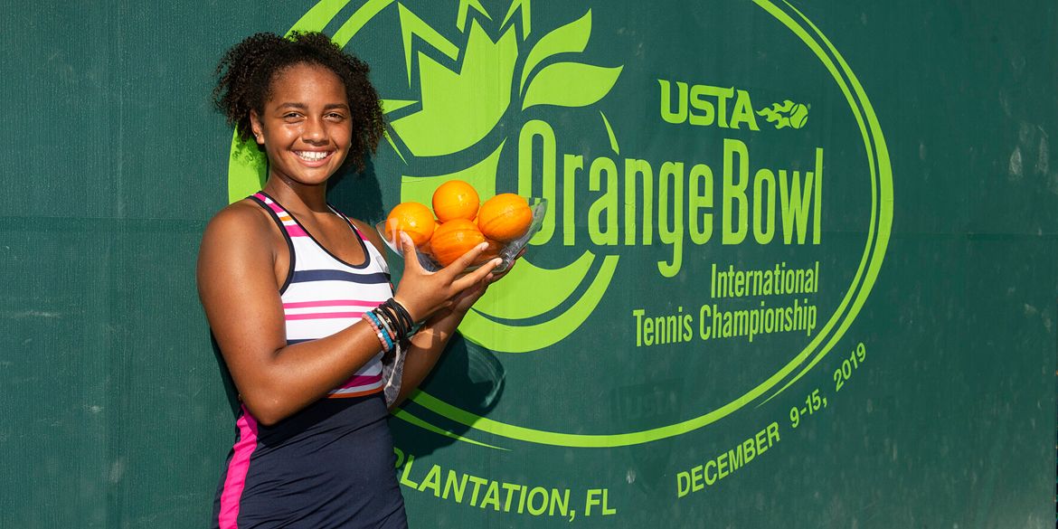 Tennis player Robin Montgomery holds a trophy at an Orange Bowl event